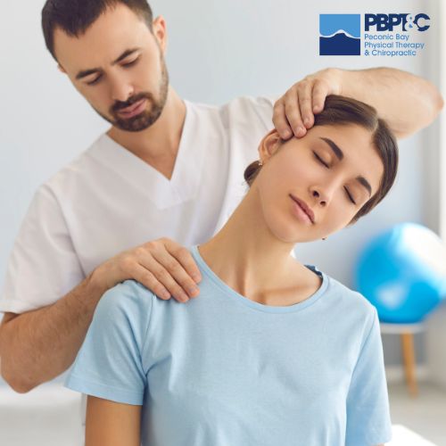 A physical therapist stretches a woman's neck while she sits, with a clinic logo visible in the top right corner.